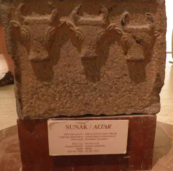 Sunak or Altar, block of stone with three bull's head design and some inscription